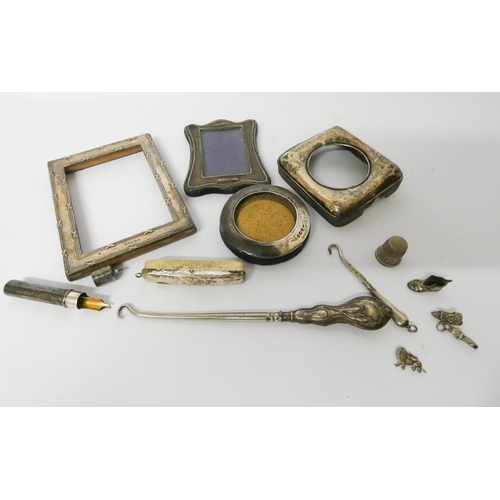 613 - A collection of small silver ware to include miniature photograph frames, silver handled button hook... 