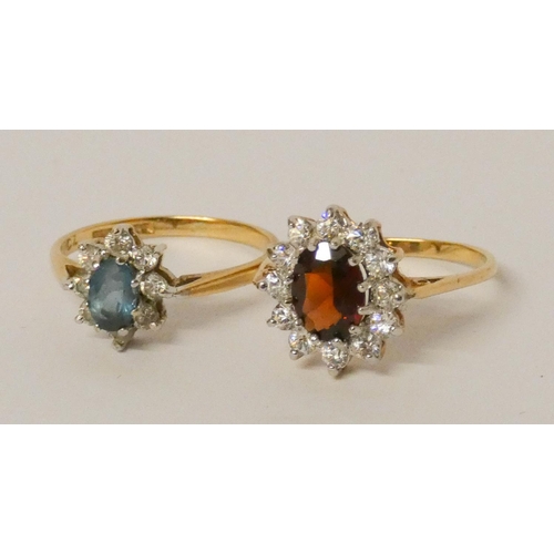 592 - Two 9ct gold ladies stone set oval cluster dress rings. Both size O