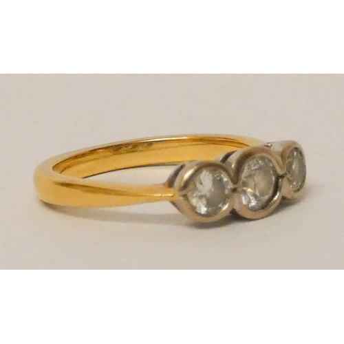 655 - 18ct gold three stone diamond ring, set three circular brilliant cut diamonds in a rub over setting.... 