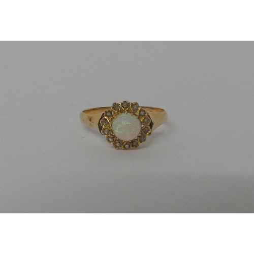 571 - Antique opal and diamond cluster ring, set with a circular cabochon opal surrounded with rose cut di... 