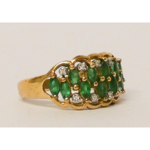 582 - An emerald and diamond ring, set two rows of marquise shaped emeralds within diamond borders on a wi... 