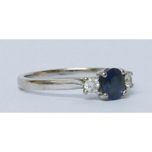 583 - A sapphire and diamond three stone ring, on 18ct white gold hallmarked band, ring size O