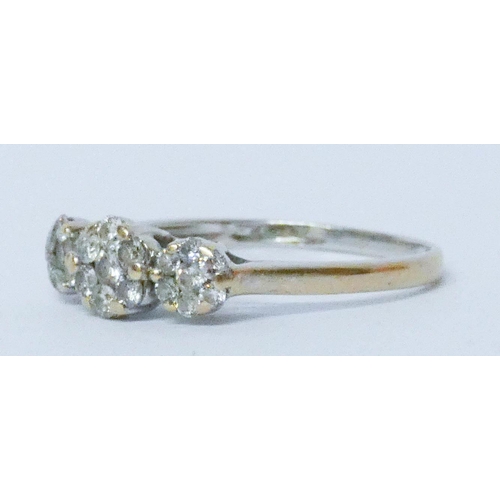 586 - A diamond triple cluster ring, on 18ct white gold band, ring size N