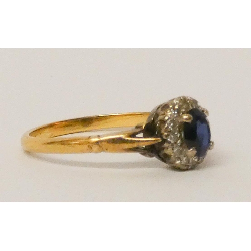 686 - An oval sapphire and diamond cluster ring, on 18ct yellow gold band. Ring size N