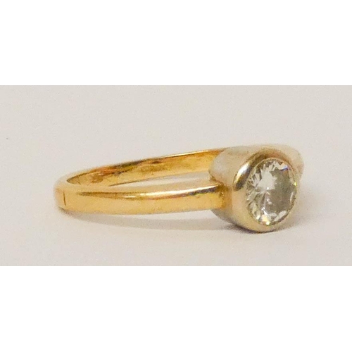 691 - A diamond solitaire ring, in an 18ct yellow gold rub over setting, hallmarked, ring size K