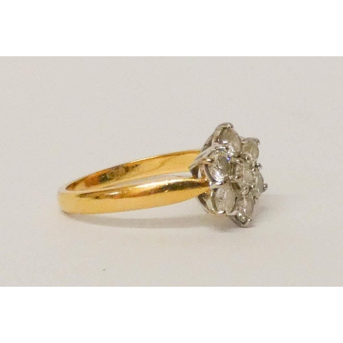 692 - A diamond daisy ring, set with seven brilliant cut diamonds, on 18ct yellow gold hallmarked shank. R... 