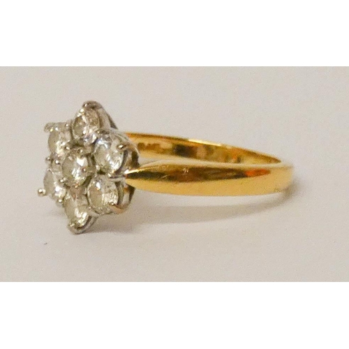 692 - A diamond daisy ring, set with seven brilliant cut diamonds, on 18ct yellow gold hallmarked shank. R... 