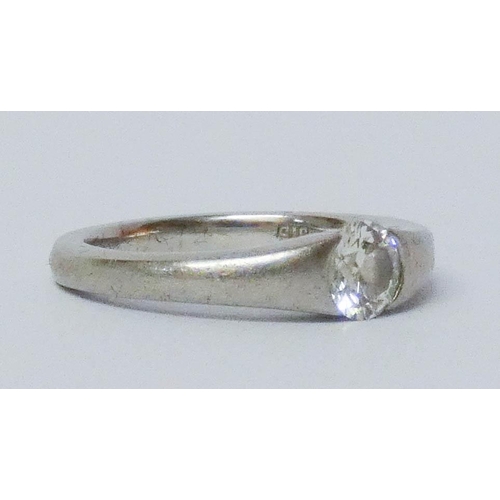 693 - A platinum single stone diamond engagement ring, in a rub over setting. Hallmarked, ring size J