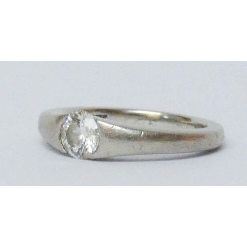 693 - A platinum single stone diamond engagement ring, in a rub over setting. Hallmarked, ring size J