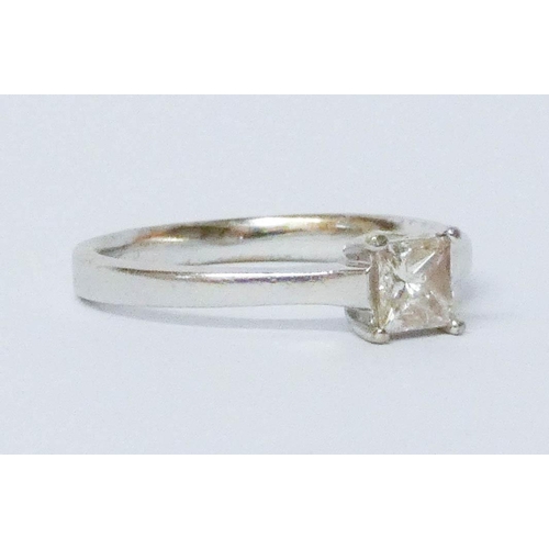 699 - A modern Princess cut diamond engagement ring, the solitaire stone weighing approximately 0/7 carats... 