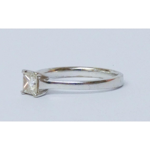 699 - A modern Princess cut diamond engagement ring, the solitaire stone weighing approximately 0/7 carats... 