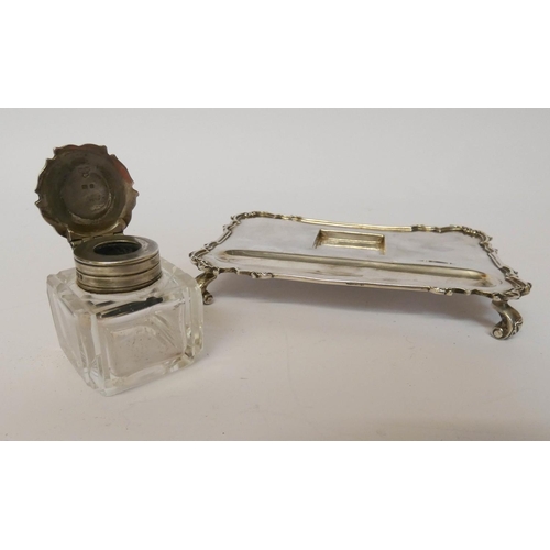 569 - A silver inkstand, with a square cut glass bottle of rectangular form, London 1931, 15cms across