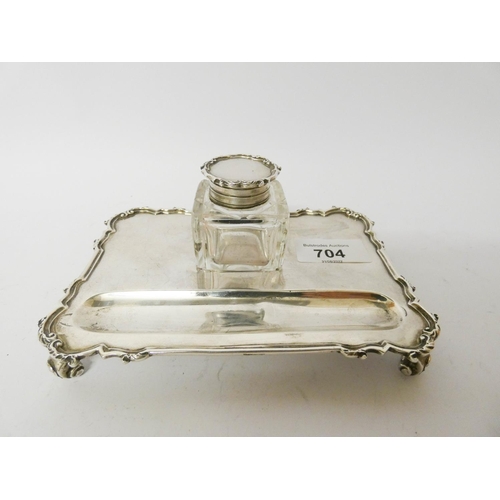 569 - A silver inkstand, with a square cut glass bottle of rectangular form, London 1931, 15cms across