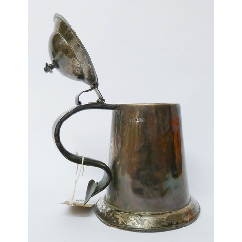 568 - A silver lidded tankard, of straight sided tapering form, the domed hinged cover with scrolled handl... 