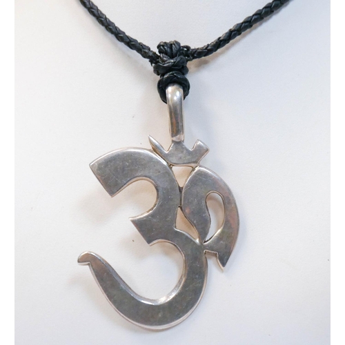 661 - A collection of silver chains and pendants and a large Buddhist silver Om pendant on leather cord.