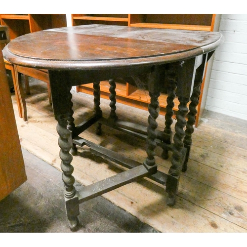 92 - A 1930s oak drop leaf gate leg dining table on barley twist legs