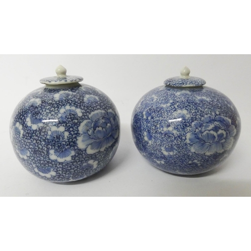 506 - A pair of Chinese blue and white porcelain spherical jars with covers 8.5 cms tall...