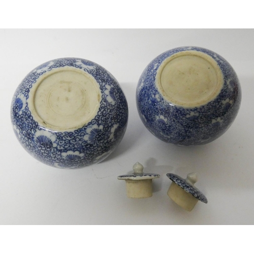 506 - A pair of Chinese blue and white porcelain spherical jars with covers 8.5 cms tall...