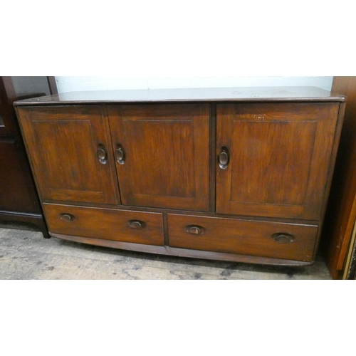 28 - An Ercol oak three door sideboard with two drawers under, 4'3 wide