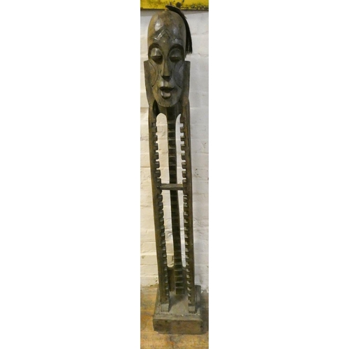 48 - A tall carved African figure CD rack