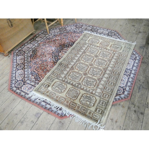 66 - A fawn Bokhara patterned rug and octagonal pink figured Wilton rug