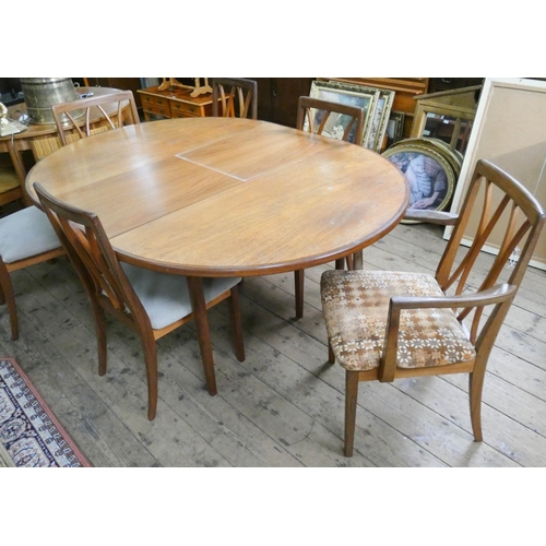 67 - An oval GPlan extending dining table with fold away centre leaf and six matching chairs, four standa... 