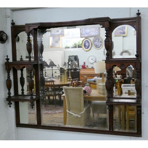 123 - An Edwardian over mantel mirror in walnut frame with trinket shelves