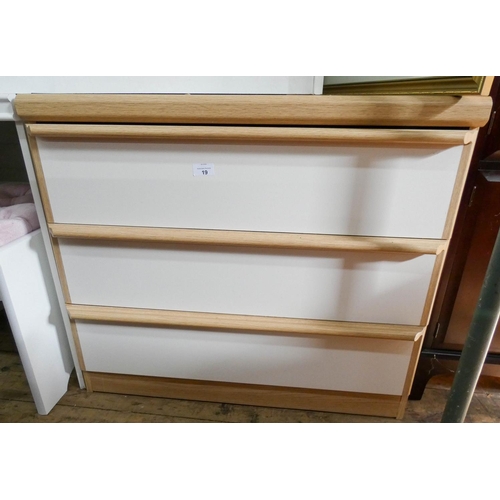 19 - A white and light oak finished chest of three drawers, 2'6 wide