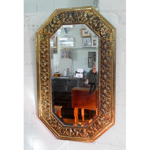 30 - A bevelled wall mirror in embossed in embossed brass frame and a circular gilt framed convex mirror