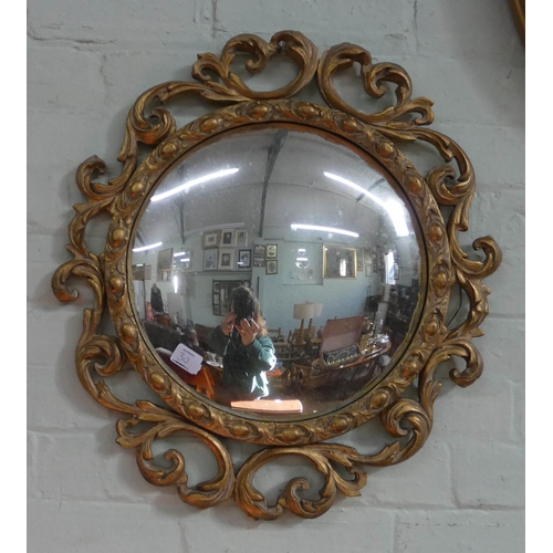 30 - A bevelled wall mirror in embossed in embossed brass frame and a circular gilt framed convex mirror