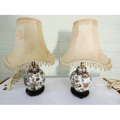 5 - A pair of oriental style china table lamps with cream butterfly decorated shades