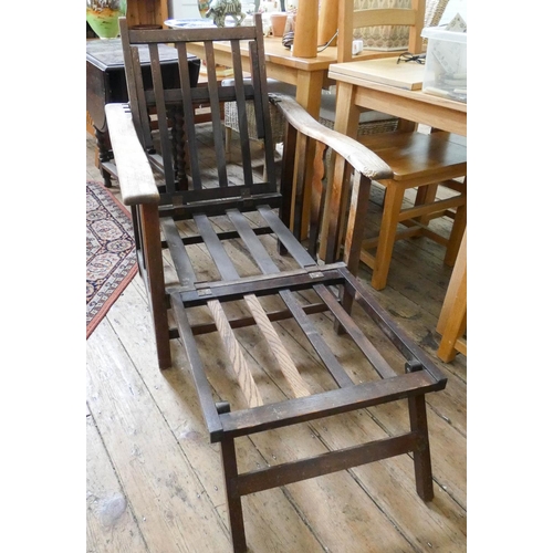 93 - A 1920's oak adjustable fireside or steamer style chair with foot rest, no cushions