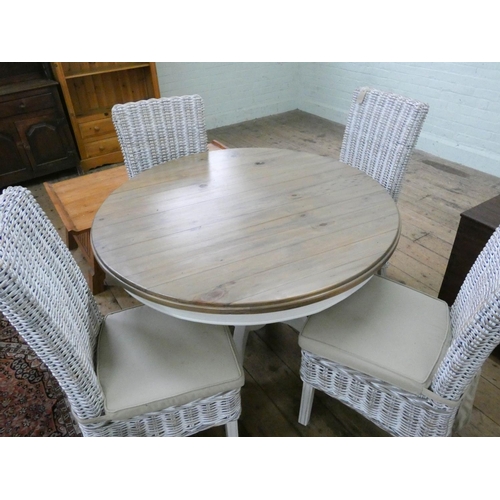 142 - Circular cream painted single pillar dining table with polished pine top with four wicker chairs wit... 