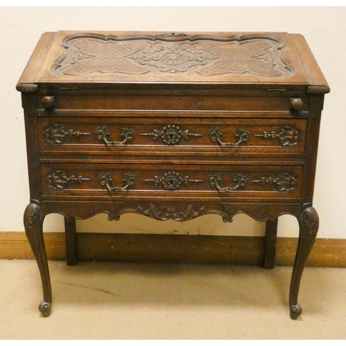 146 - Early 20th century carved oak writing bureau with fitted interior, two long drawers under, standing ... 