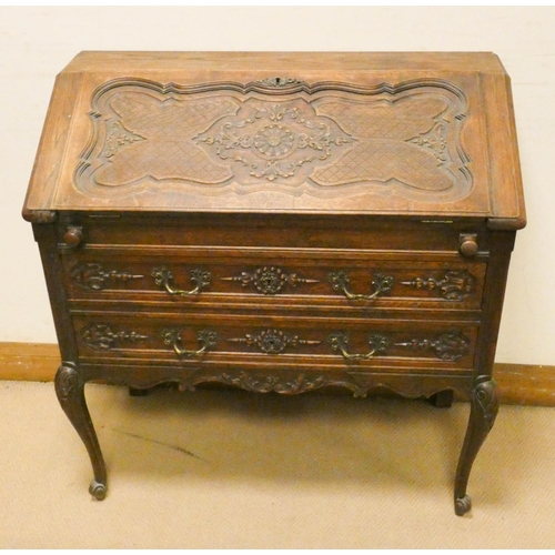 146 - Early 20th century carved oak writing bureau with fitted interior, two long drawers under, standing ... 