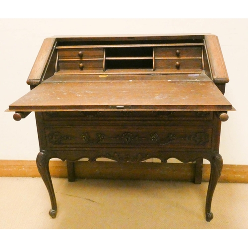 146 - Early 20th century carved oak writing bureau with fitted interior, two long drawers under, standing ... 