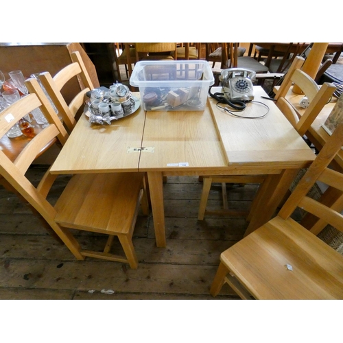 108 - A modern light oak fold over top dining table and four ladder back style chairs with panel seats