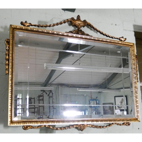 127 - A Victorian style bevelled wall mirror in decorative gilt frame