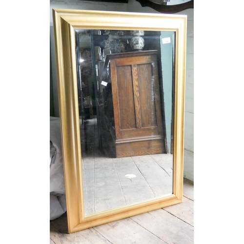 132 - A bevelled wall mirror in gilt frame