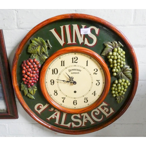 137 - A circular wall clock in a vine decorated frame and a framed oil painting