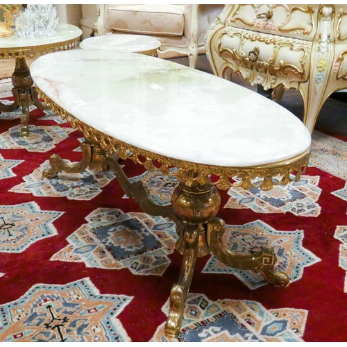 152 - A long oval brass framed coffee table with onyx top, 3'9 long