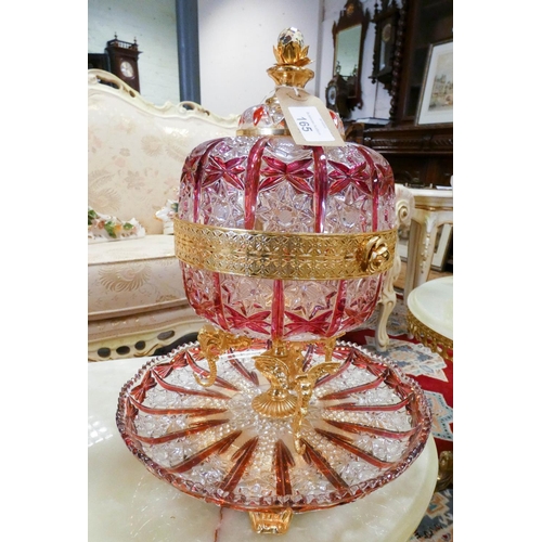 165 - An ornate cut ruby glass table centre piece casket and cover, with ornate gilt metal stand and integ... 