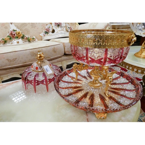 165 - An ornate cut ruby glass table centre piece casket and cover, with ornate gilt metal stand and integ... 