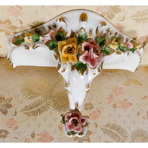 167 - A Capodimonte white gilt and floral encrusted china wall bracket and another similar wall bracket