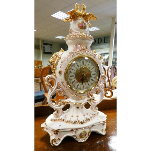 171 - An Italian cream floral and gilt decorated mantel clock