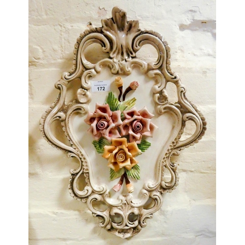 172 - A shaped floral encrusted china wall plaque