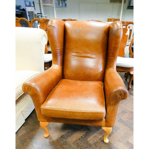 178 - A Marks & Spencer's Georgian style wing backed easy chair in antiqued brown leather