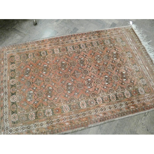 226 - A red and patterned Persian rug, 6'3 X 4' (faded)