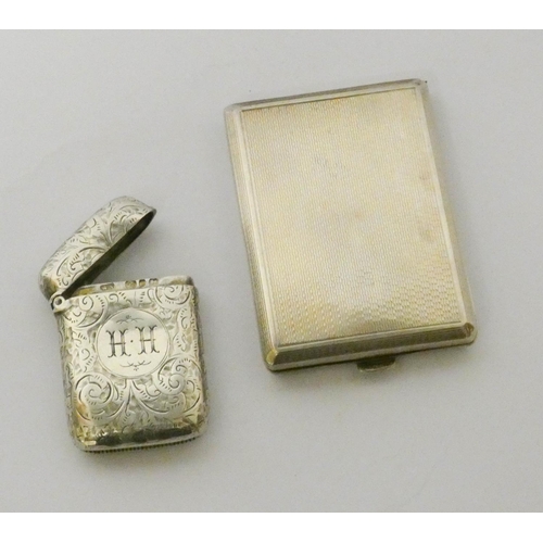 465 - A silver engine turned match case and a silver engraved vesta case