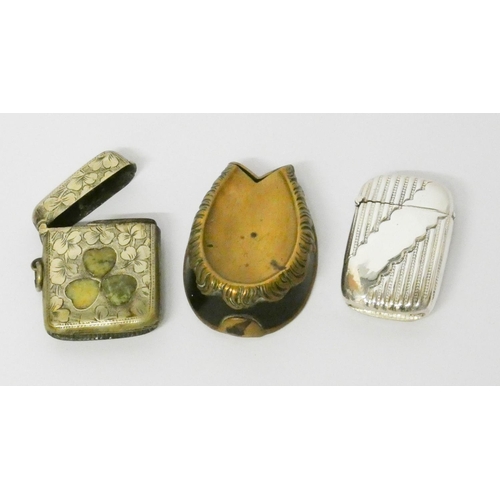 470 - Shamrock decorated vesta case, a brass horseshoe shaped vesta and a silver plated vesta engraved The... 